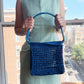 Model holding the market raffia bag in blue
