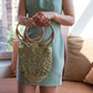Model holding the Piña raffia bag in green