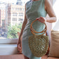 Model wearing Surena crochet pina raffia bag in green